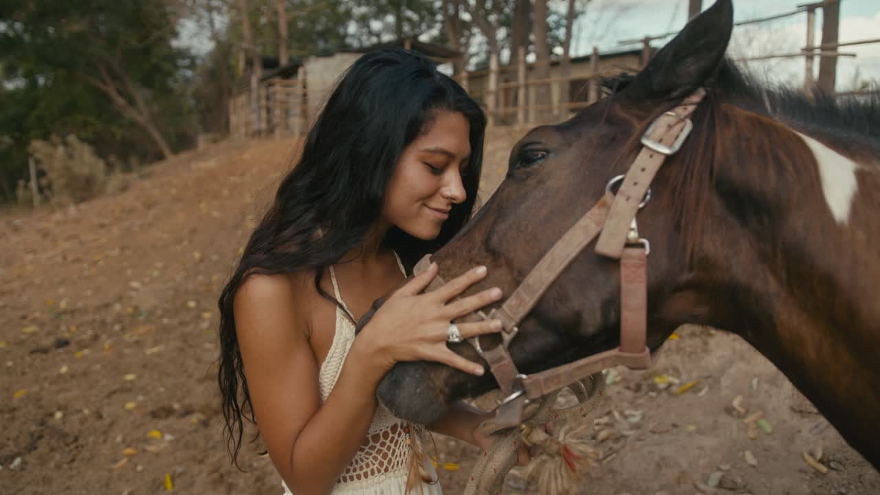 Woman bonding with a horse at a ranch