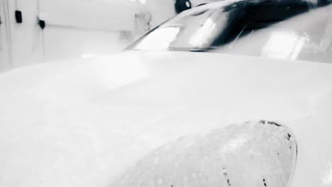 washing soap off white car hood