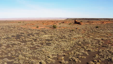 desertscape: wukoki pueblo ruins in the middle of desert surrounded by red sandstone