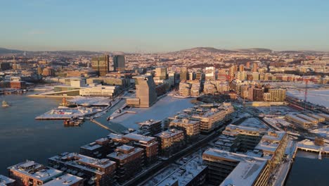 Golden-Hour-View-Over-Bjorvika-In-Sentrum-borough-of-Oslo,-Norway-With-Fog-Floating-Over-Water