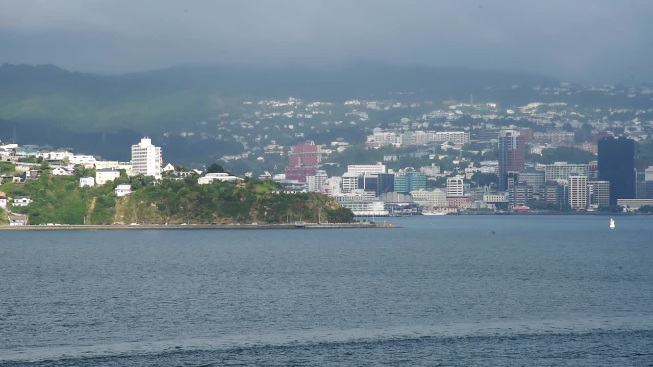 The bay of Wellington views from the leaving ferry. Skyline in the hills in the background. wide angle slide left.