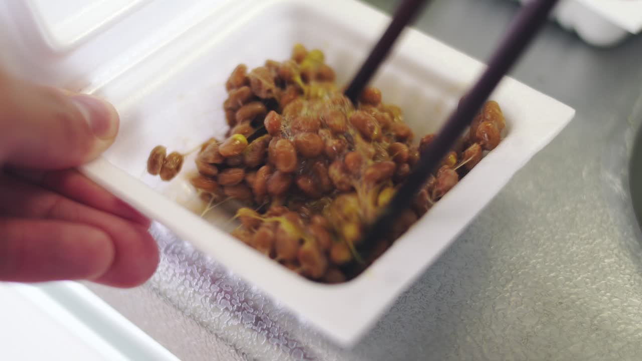 Mixing Natto Fermented Beans A Kind of Traditional Japanese Food With Mustard And Soy Sauce.  -close up shot