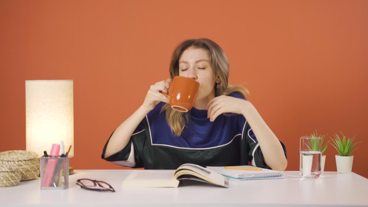 The young woman's mouth is burning from the hot drink.