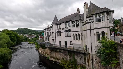 river flowing by historic building and bridge