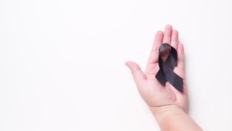 black awareness ribbon on gray background