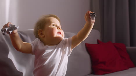 Vista-Frontal-De-Un-Bebé-Jugando-En-El-Sofá-En-La-Sala-De-Estar-En-Casa-Con-Juguetes-De-Animales