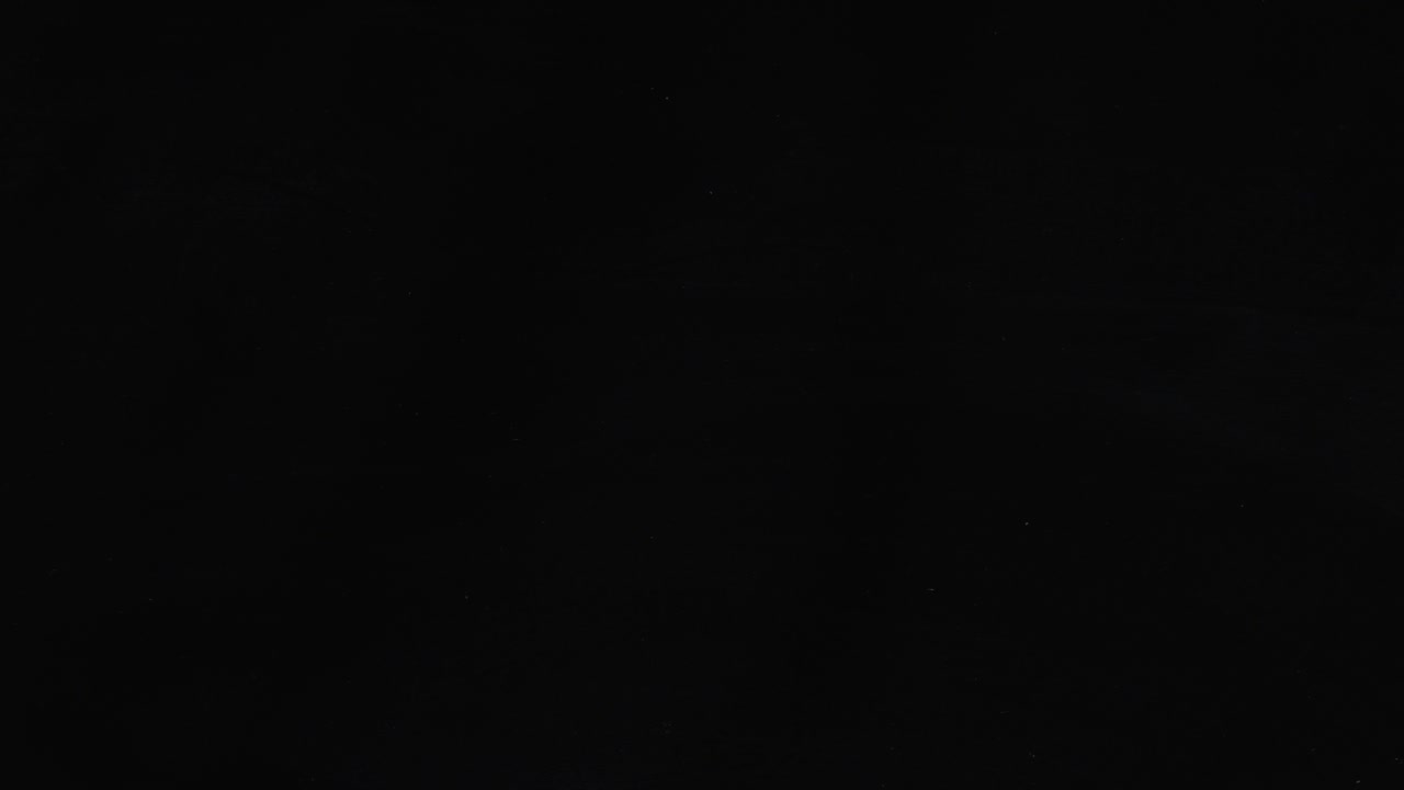 Glass slowly cracking and shattering on black background. Abstract effect for impact, breaking, or transition. Minimalist video