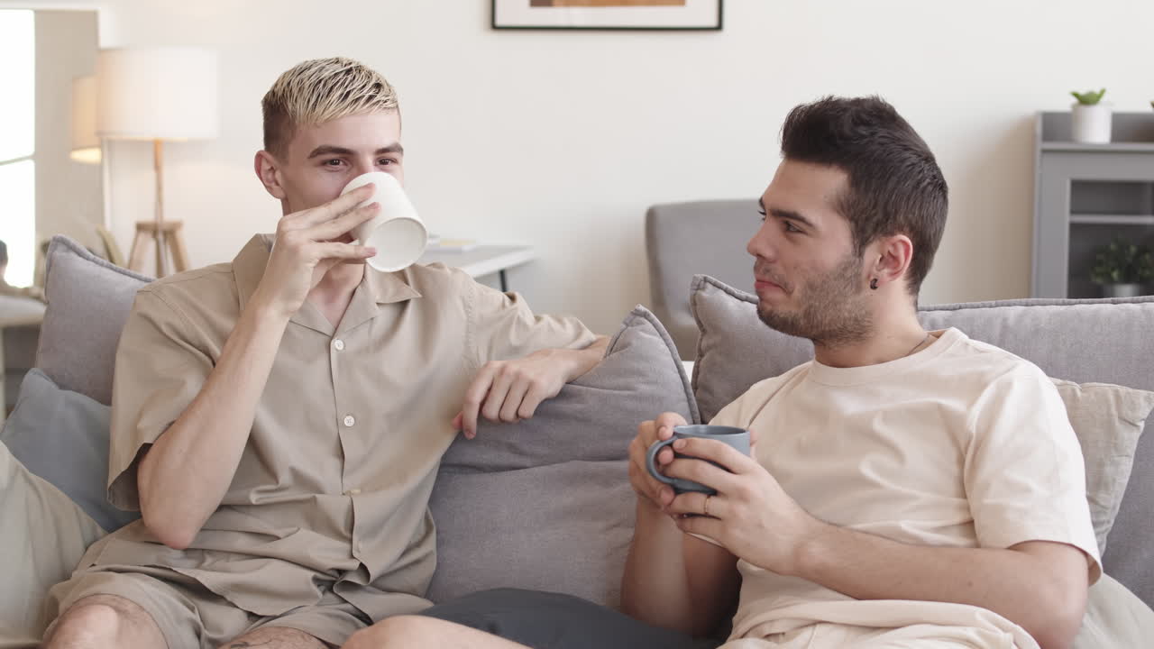 Two Young Men Drinking Tea and Talking