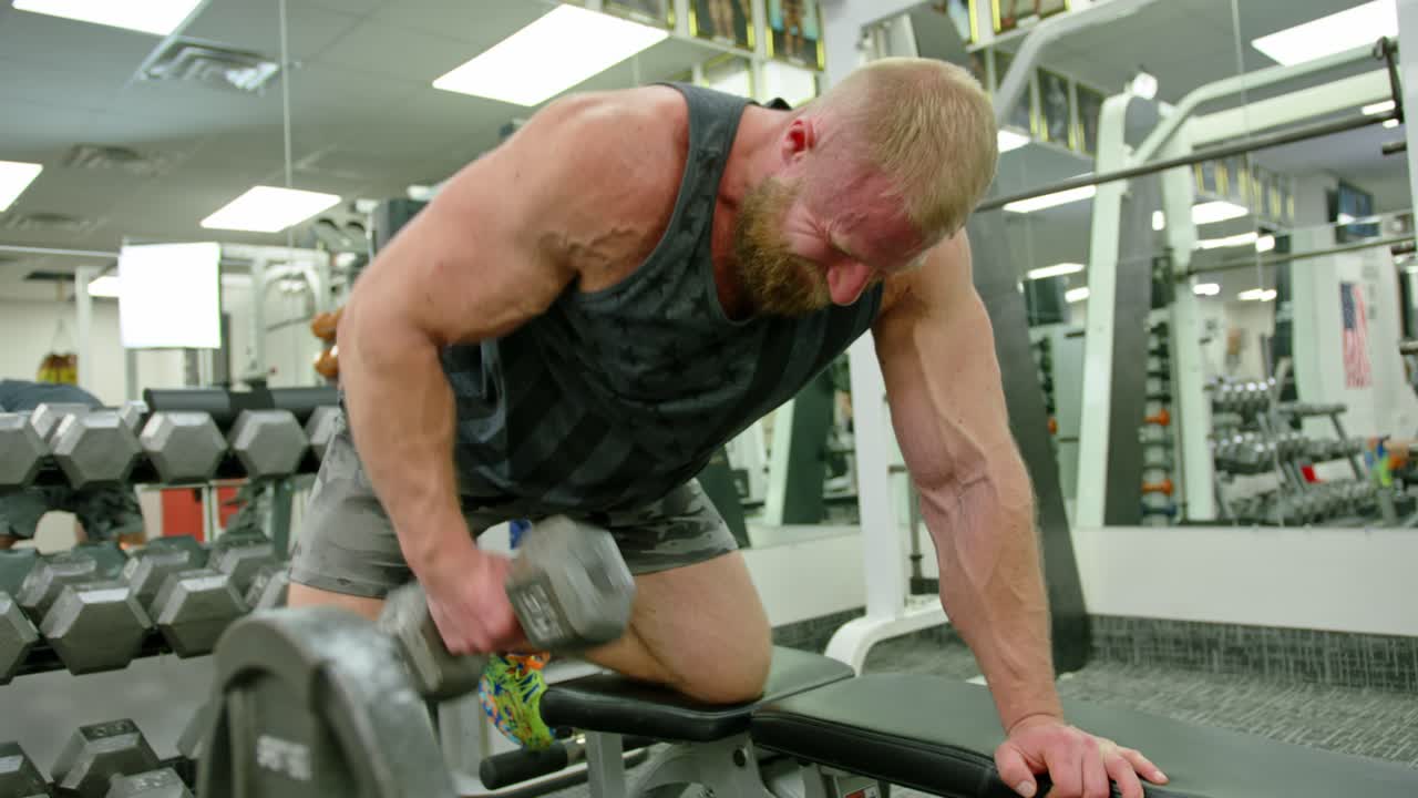 Muscular bodybuilder handsome men doing exercises in gym