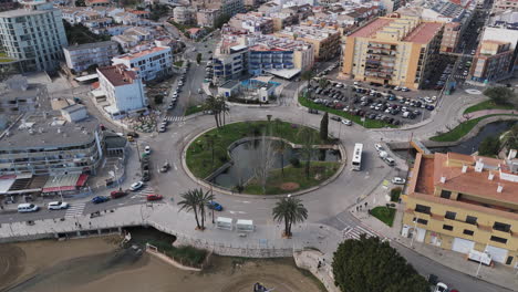 topdown drone of placa constitució roundabout with roads, trees, and beach visible nearby