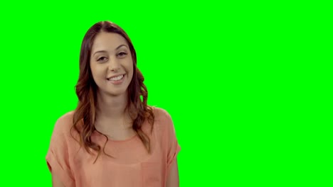 Smiling-beautiful-woman-standing-against-green-screen