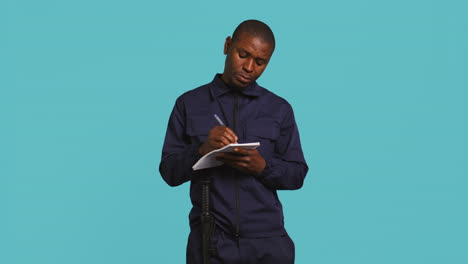 portrait of bodyguard using pen, documenting orders on notepad