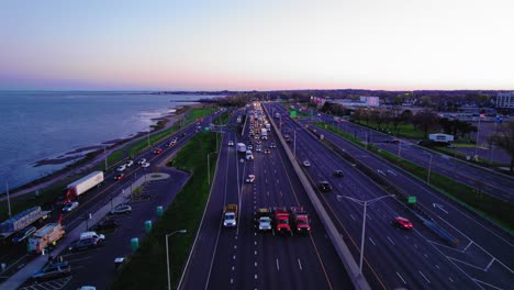 convoy of impact attenuator trucks and police car operation on i-95 in new haven, ct, usa