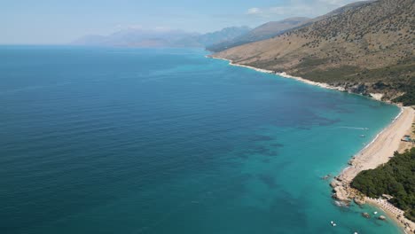 high angle overview of sand and reef on tropical beach with beautiful blue sky