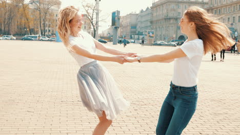 two girls dancing in city