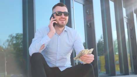 bearded man, long beard, brutal hipster with moustache on serious sits on the steps