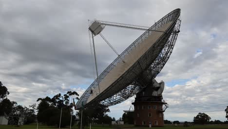 time-lapse of a satellite dish rotating under cloudy sky