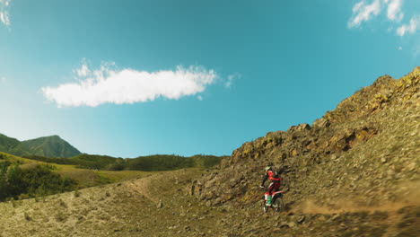 motorcyclist navigates challenging slopes. racer shows determination pushing limits of machine and man in pursuit of motocross mastery among hilly terrain