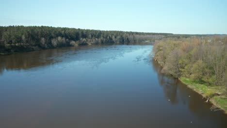 aerial: reveal shot and flying above river nemunas on sunny day