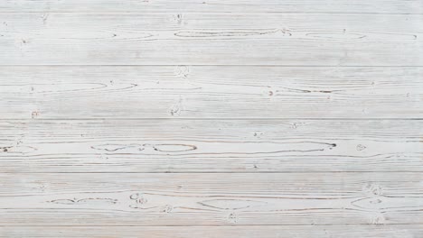 christmas gifts appear in female hands on a light wooden background, stop motion