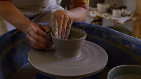 Young-female-potter-working-in-her-studio