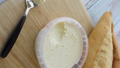 butter and baguette on wooden cutting board