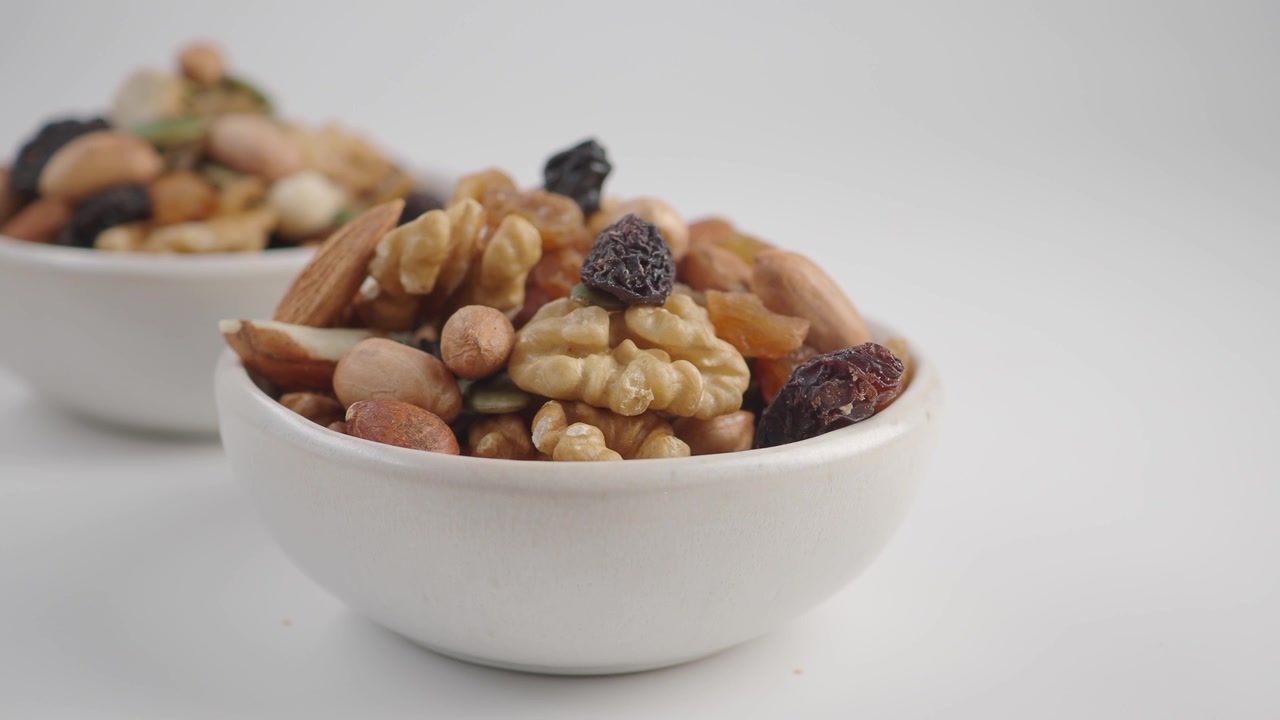 Two Bowls Filled with Assorted Nuts and Dried Fruit
