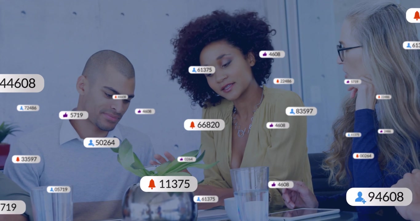 Marketing team tapping tablet triggers floating media icons highlighting rising engagement metrics