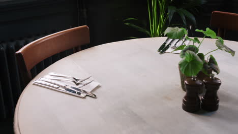 close up of table and chairs set for service in empty restaurant