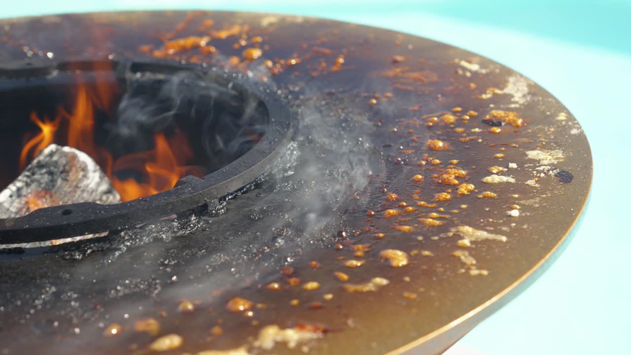 Intense burning fire pit with visible smoke, detail shot