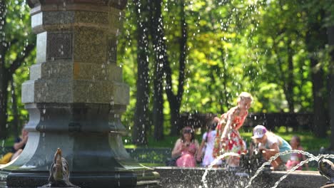 children playing at a fountain in a park