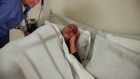 a nurse caring for an elderly patient in a hospital bed