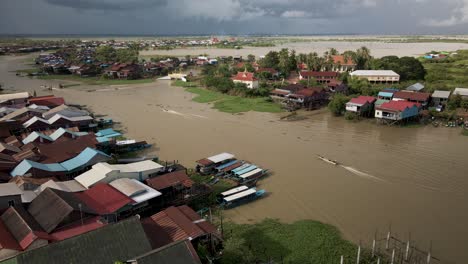 flooded village during monsoon season with fishing boats, south east asia