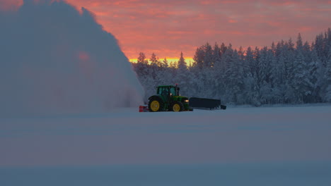 glowing sunrise over tractor snow blower preparing norbotten lapland ice track