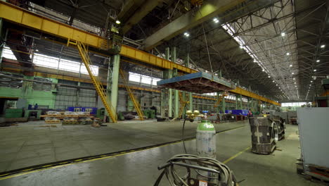 industrial factory interior with crane and workers