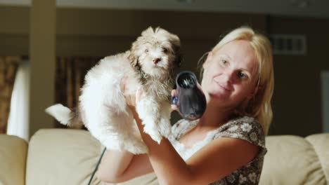 cheerful woman dries her hair with a brown puppy