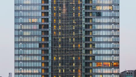 time lapse of elevator move up and down, people work, office window view on business center building facade. corporate business, office worker life, or building exterior architecture concept. tilt up