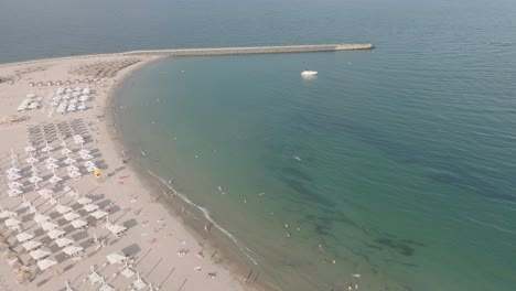 Tourists-On-Summer-Vacation-At-Reyna-Beach-And-Pier-In-Constanța,-Romania