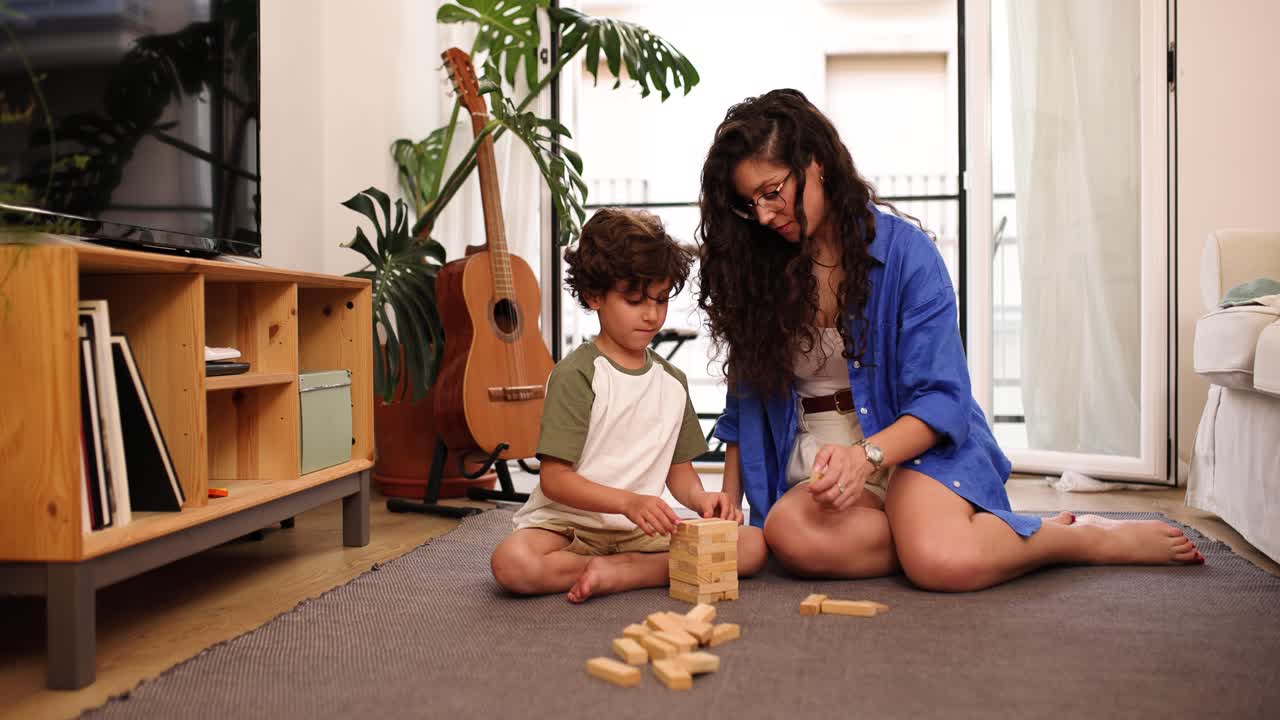 Mother and son sitting with stacking blocks