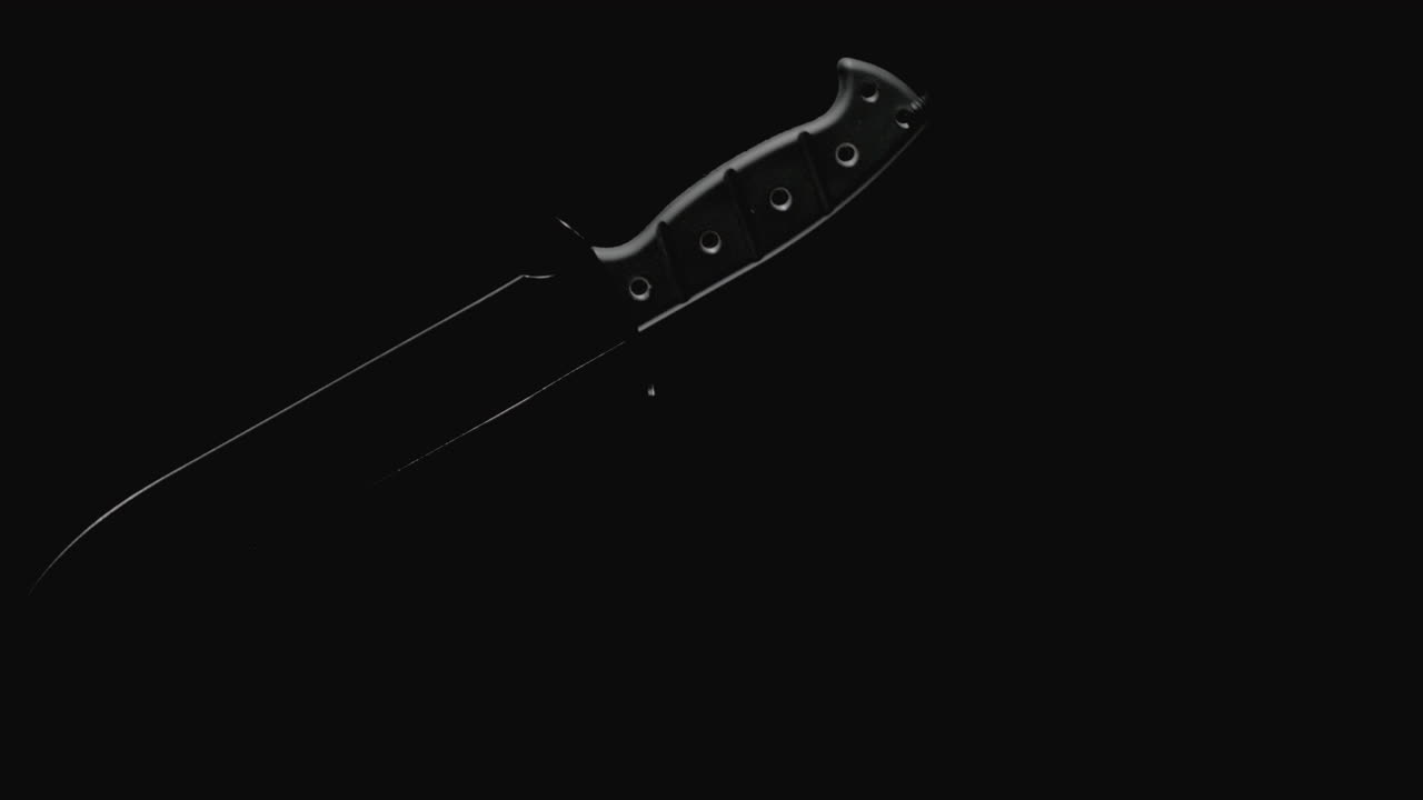 Knives on the dark background and in blinking light rotate in slowmotion
