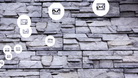 Animation-of-message-icons-floating-against-stone-wall-background