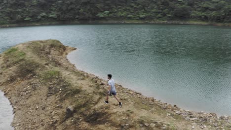 young man enjoying the summer walk along lake danao in ormoc, leyte, philippines - drone shot