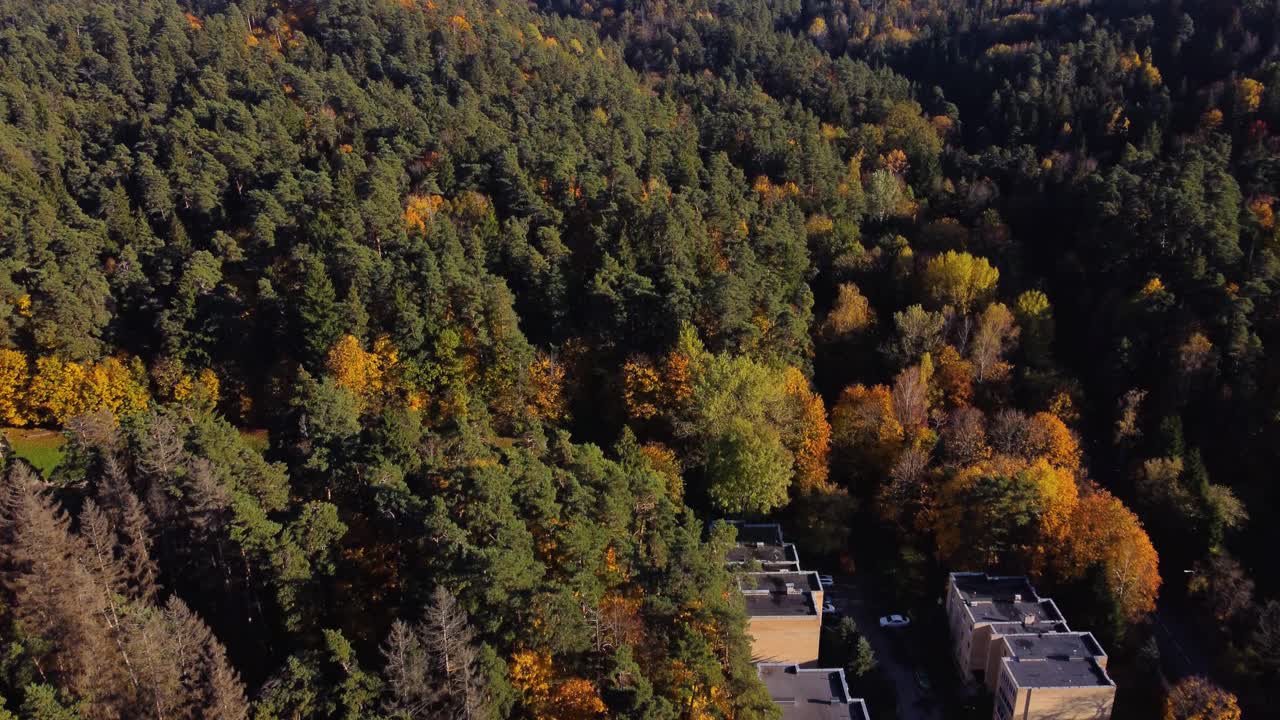 AERIAL Shot a Residential Area deep within a Hilly Forest during Autumn in Antakalnis District, Vilnius, Lithuania