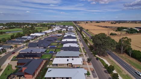 aerial showing on one side of the midland highway there are new houses and on the other side are farm fields
