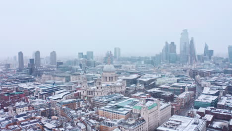 london snow aerial drone shot st pauls cathedral skyscrapers in background