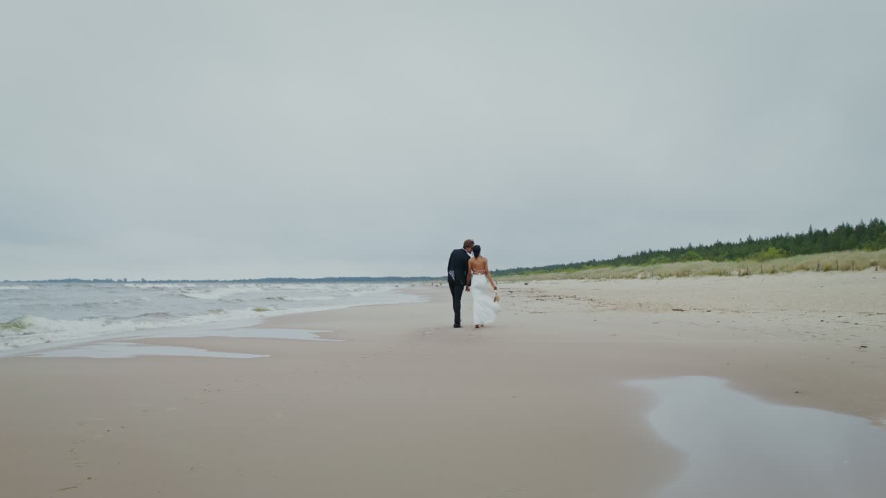 Bride and Groom Walking on the Beach