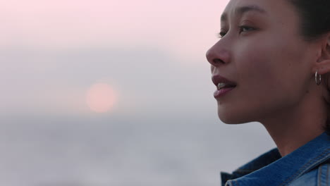 portrait of beautiful asian woman smiling enjoying carefree lifestyle exploring freedom on vacation looking happy with wind blowing hair