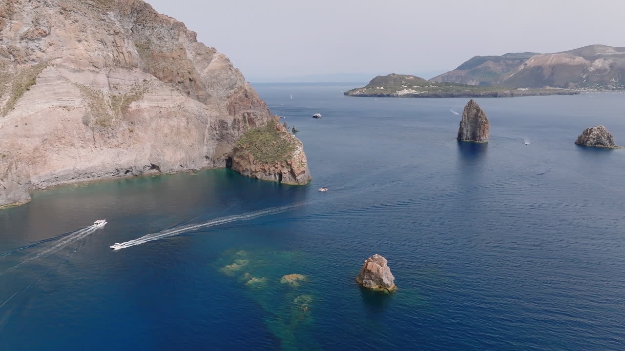 Scenic Coastal Landscape with Cliffs, Sea Stacks, and Boats in Blue Waters
