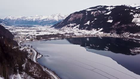 Aerial-view-of-Zell-am-see,-Austria,-snow-covered-village,-circle-pan,-day