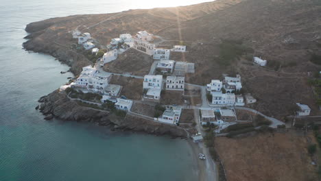 aerial drone flight circling a few white houses at the island of tinos